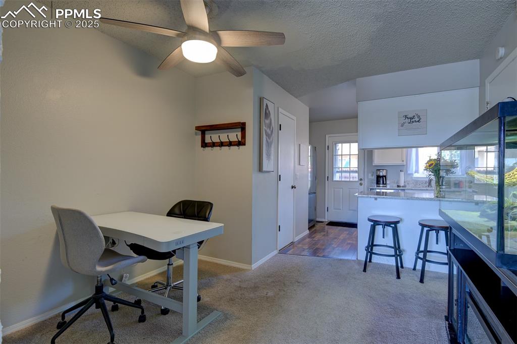 Image 5 of 34: Dining area off the kitchen showing the breakfast bar