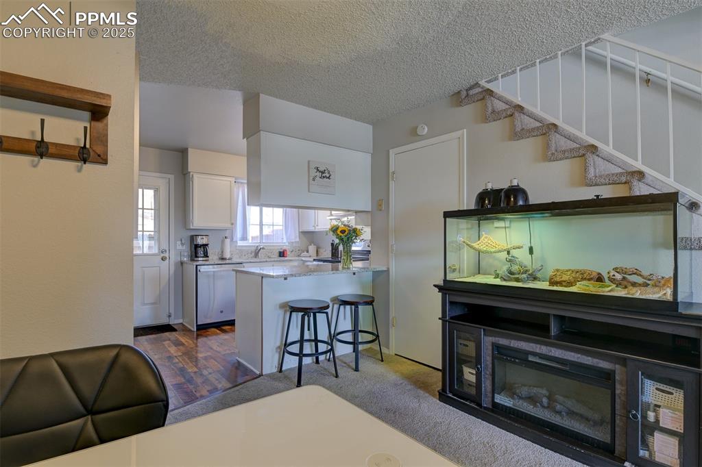 Image 6 of 34: Dining area off the kitchen showing the breakfast bar