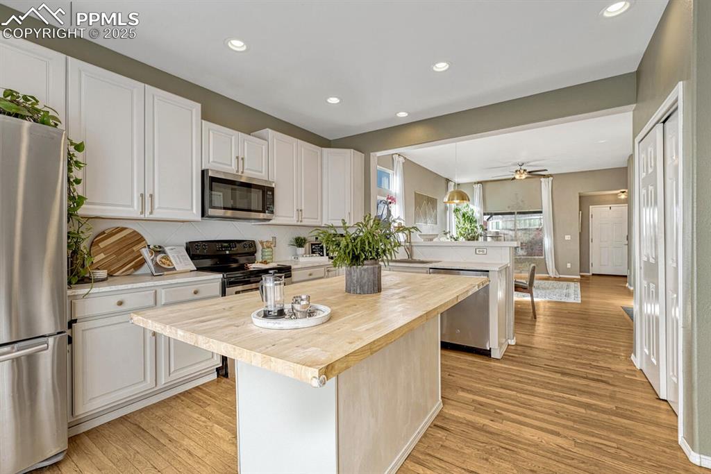 Image 11 of 47: Remodelled kitchen with large butcher block countertop.