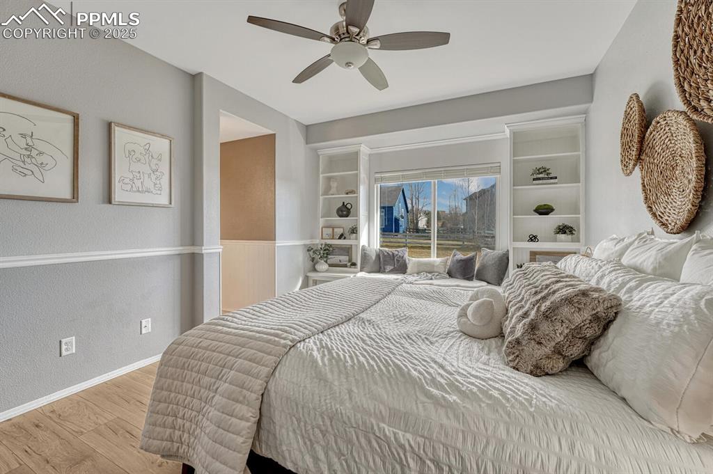 Image 20 of 47: Wall of built-ins and charming window seat.