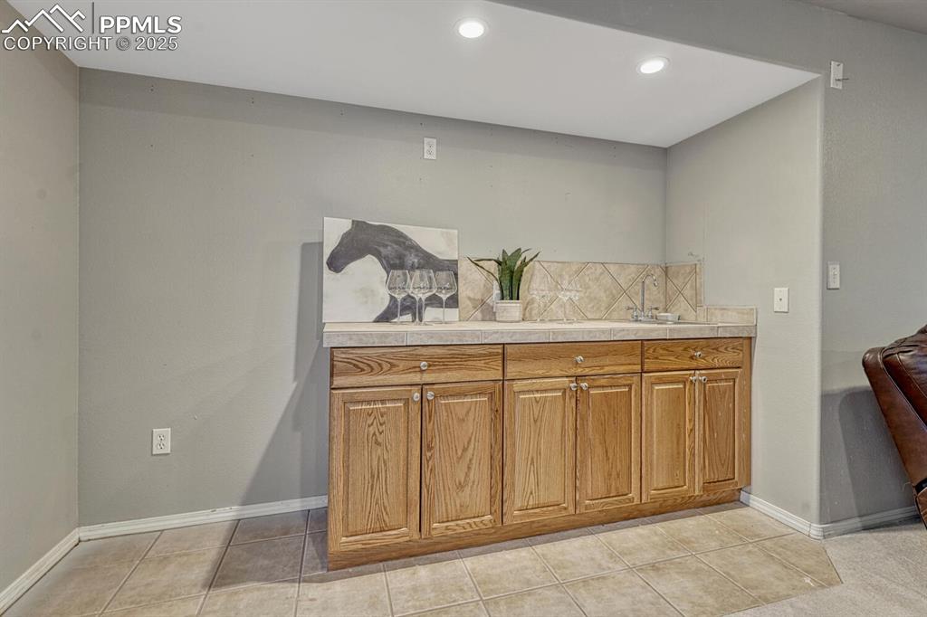 Image 29 of 47: Basement with wetbar.