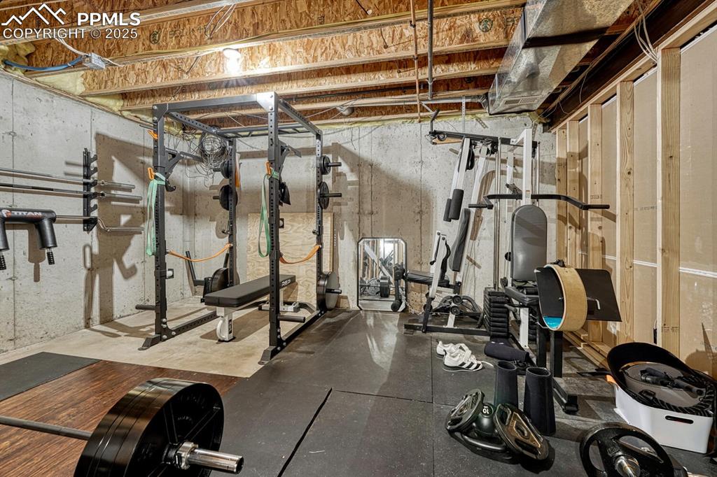 Image 33 of 47: Large storage room, currently utilized as a gym.