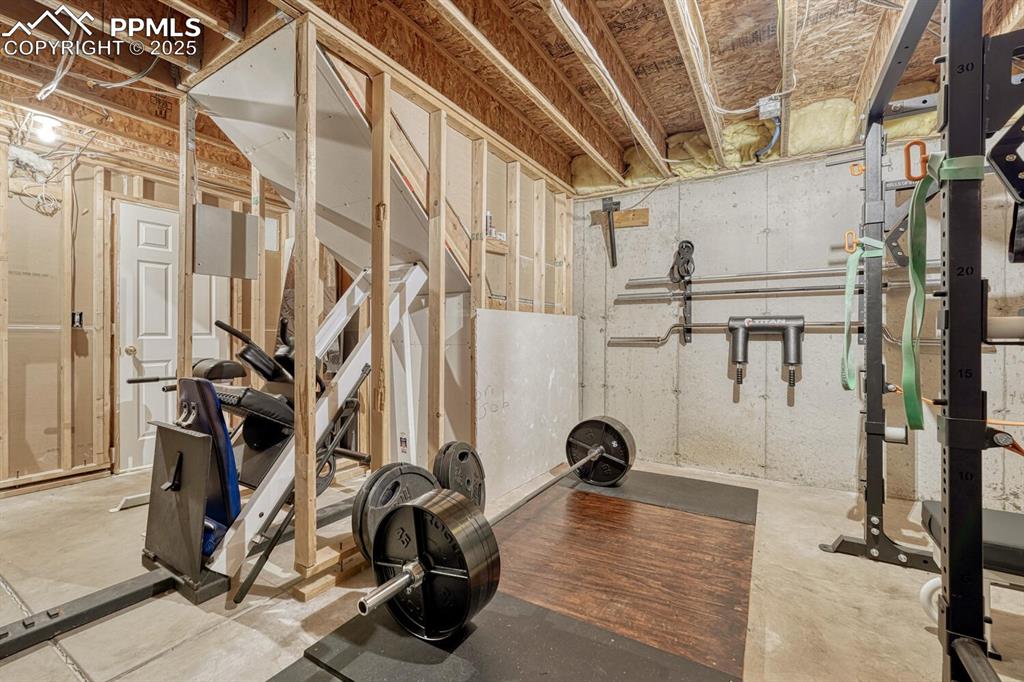 Image 34 of 47: Large storage room, currently utilized as a gym.