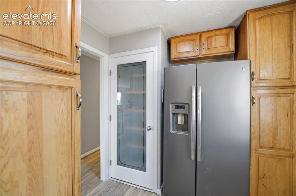 Image 11 of 48: Mud Space, Pantry, Fridge, Extra Cabinets