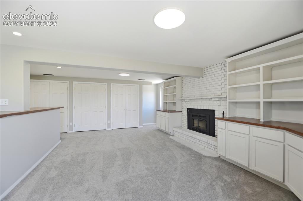 Image 23 of 48: Carpet, Closets, Built Ins, Fireplace, Dry Bar