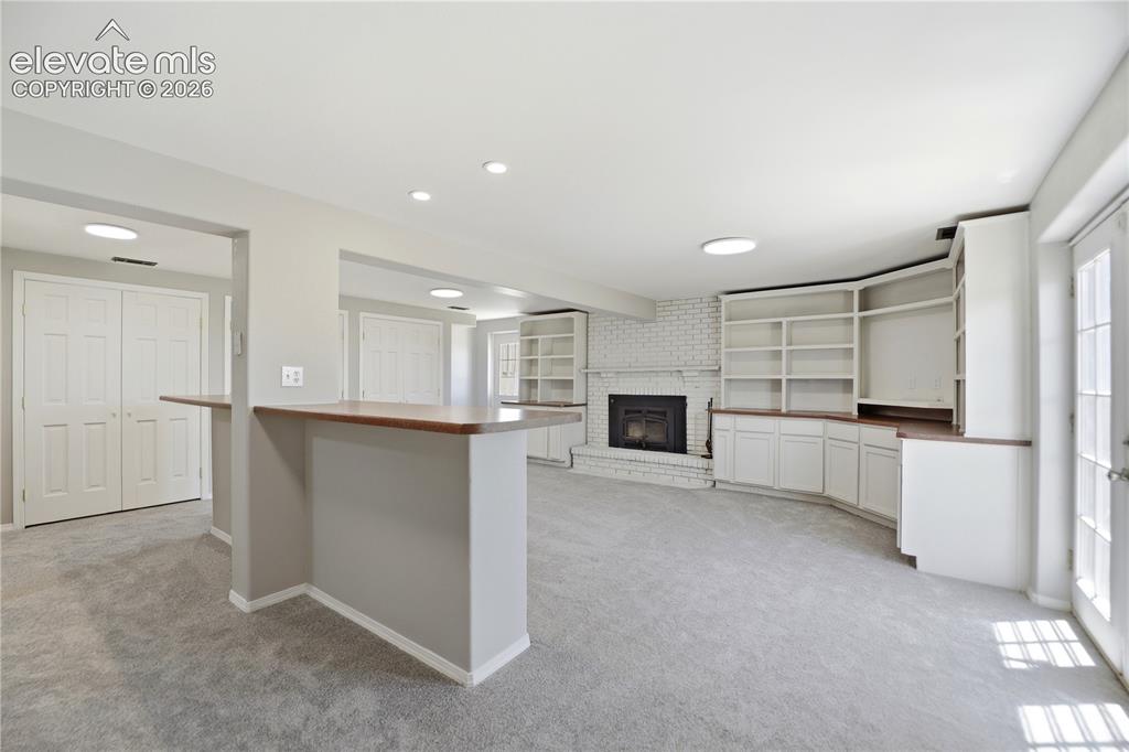 Image 24 of 48: Carpet, Closets, Built Ins, Fireplace, Dry Bar