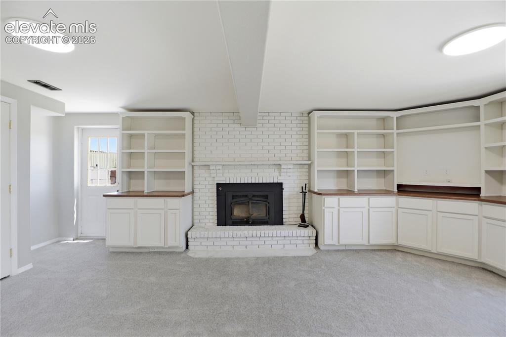 Image 25 of 48: Carpet, Closets, Built Ins, Fireplace, Dry Bar