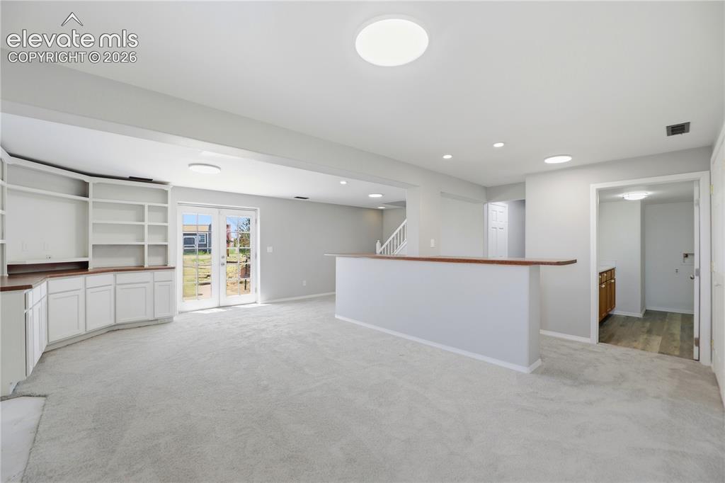 Image 26 of 48: Carpet, Closets, Built Ins, Fireplace, Dry Bar