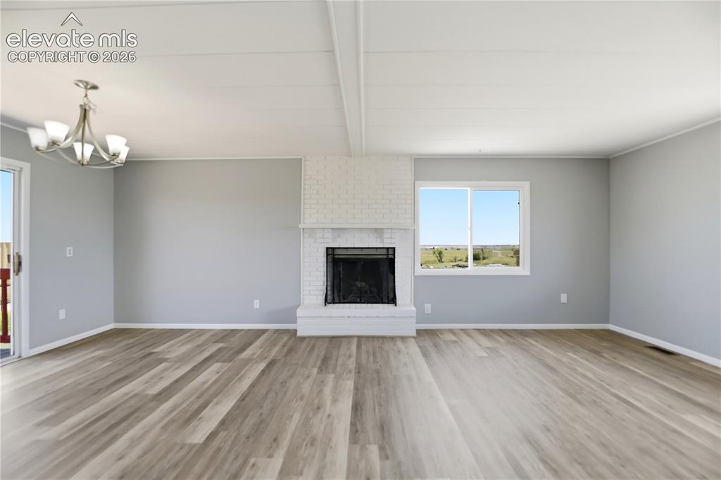 Image 4 of 48: Vinyl Plank, Fireplace, Sliding Door To Deck