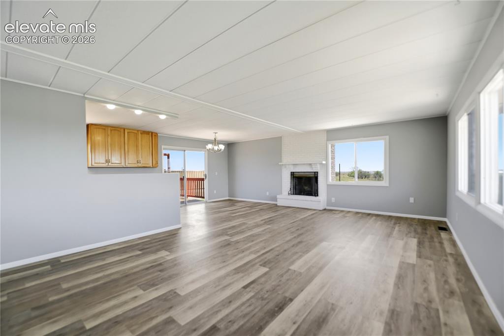 Image 5 of 48: Vinyl Plank, Fireplace, Sliding Door To Deck