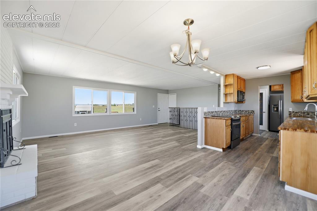 Image 7 of 48: Vinyl Plank, Fireplace, Sliding Door To Deck, Dining Area