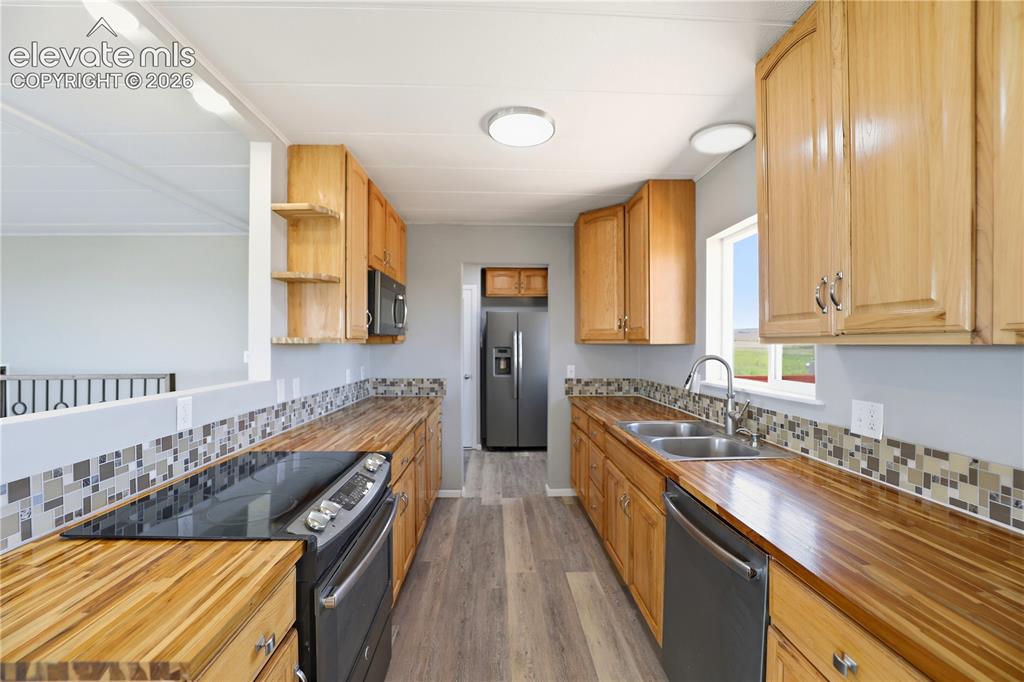 Image 8 of 48: Butcher Block, Open Concept, Vinyl Plank, Mud Space Through Kitchen, Dining