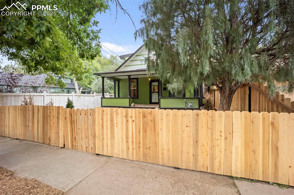 Image 3 of 48: View of front facade featuring a fenced front yard