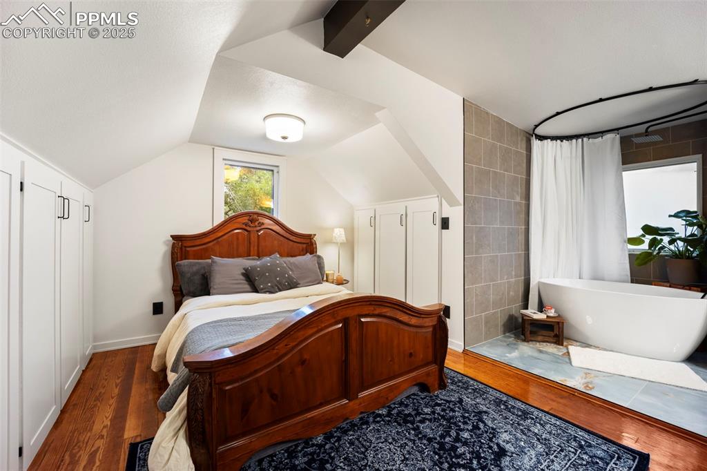 Image 31 of 48: Bedroom with wood finished floors