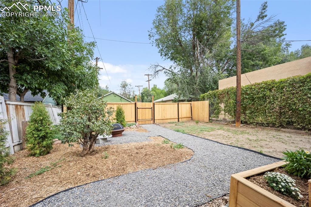 Image 36 of 48: Fenced backyard featuring a gate