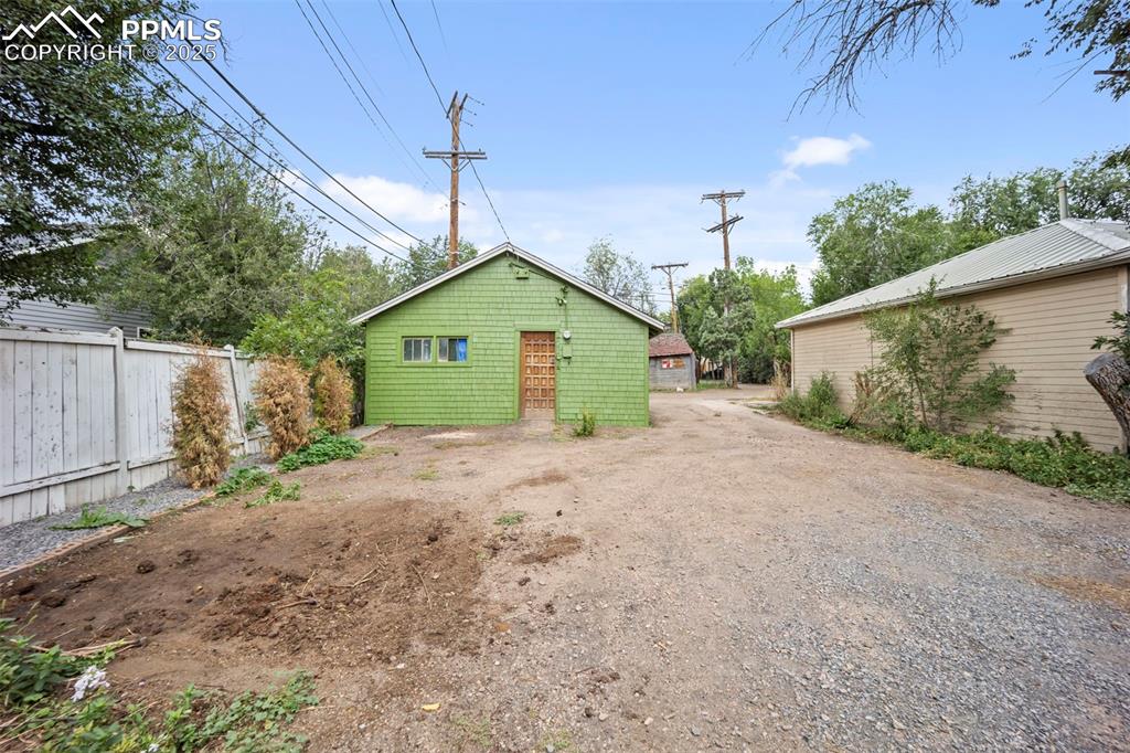 Image 40 of 48: Rear view of property with an outbuilding