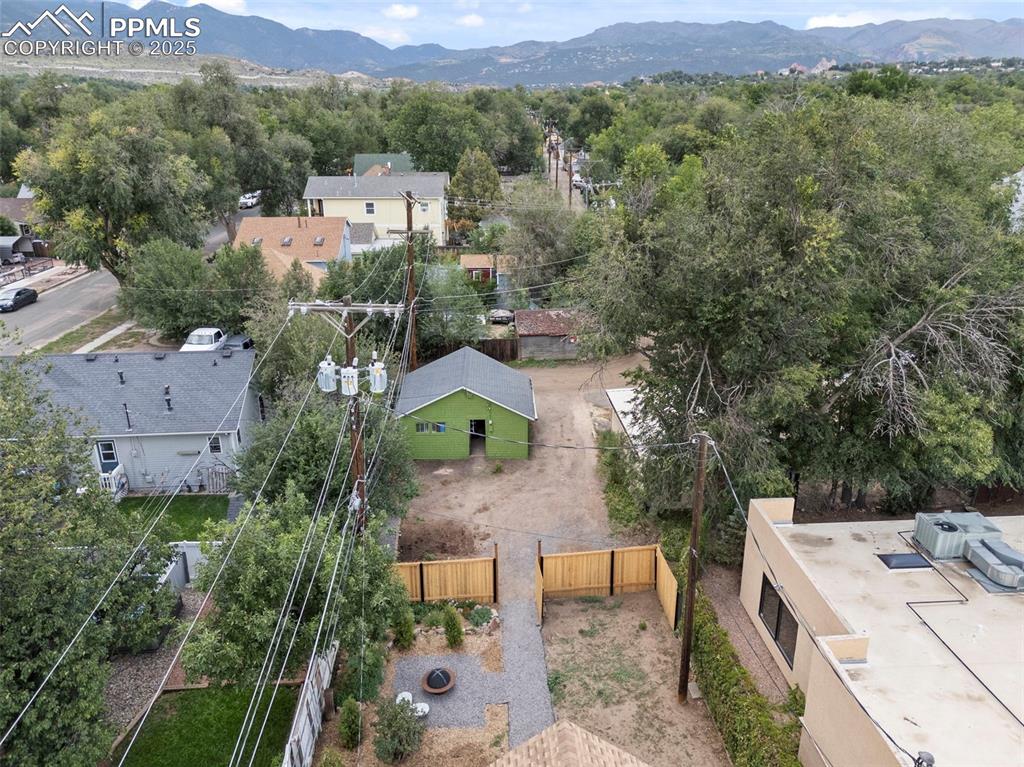 Image 43 of 48: Aerial perspective of suburban area with a mountainous background