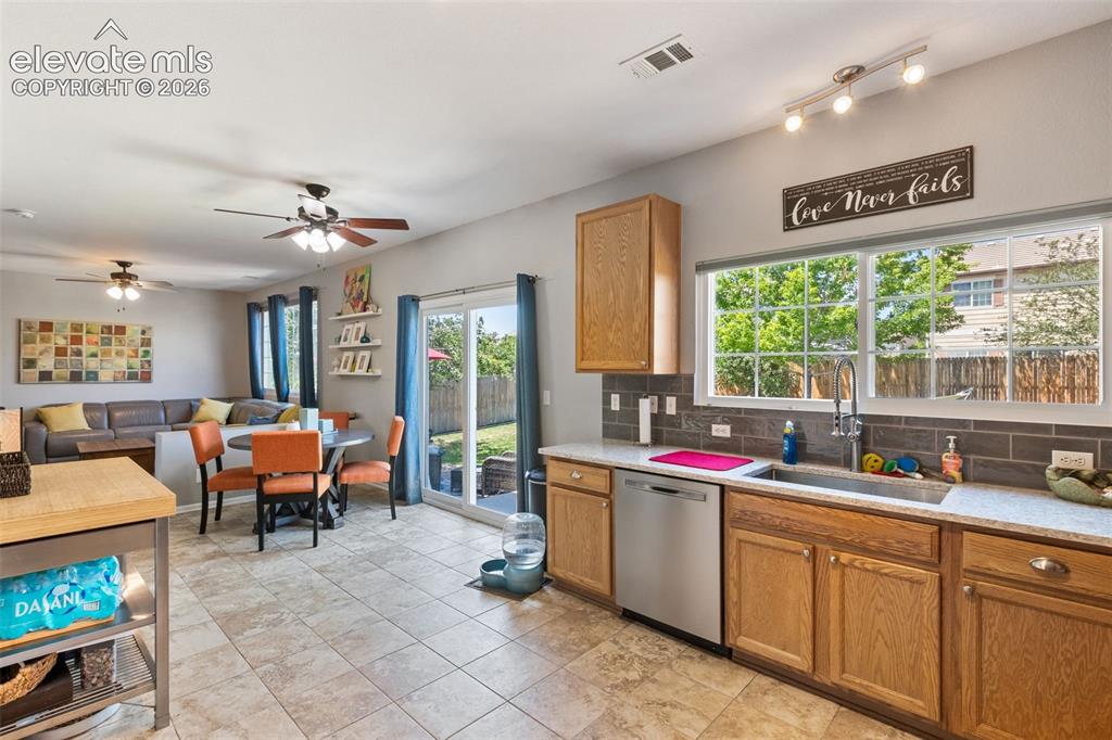 Image 11 of 39: Kitchen looking towards dining area & family room with walk-out to patio.