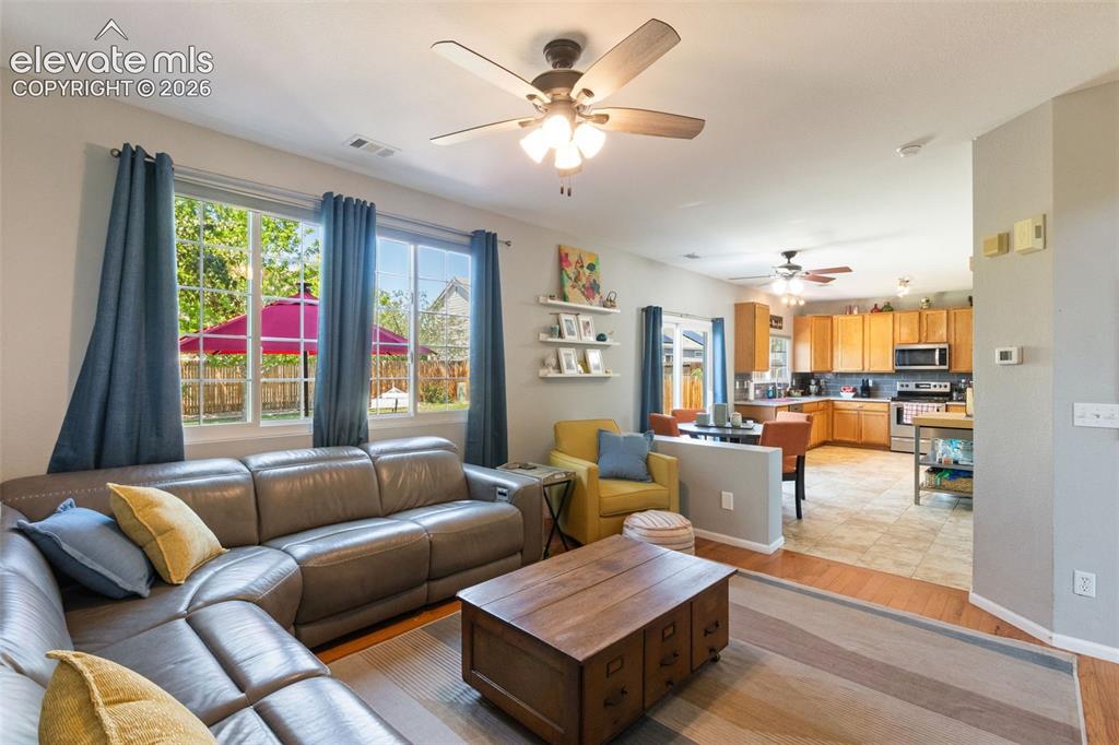 Image 16 of 39: Family room looking towards kitchen. Large windows provide lots of light.