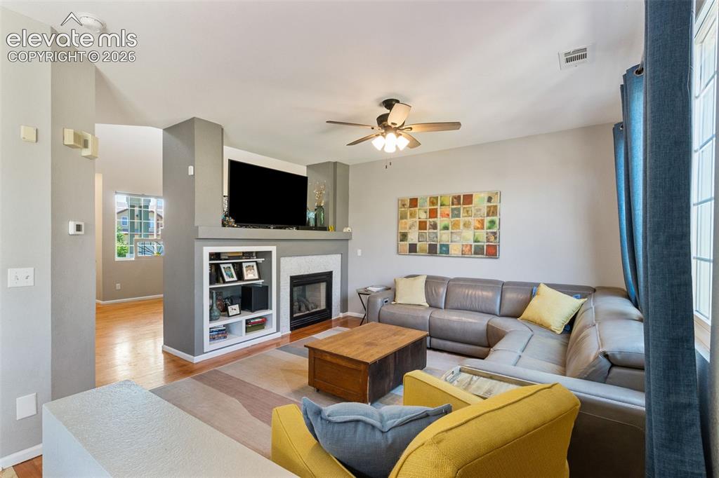 Image 17 of 39: Family room with fireplace & built-ins.