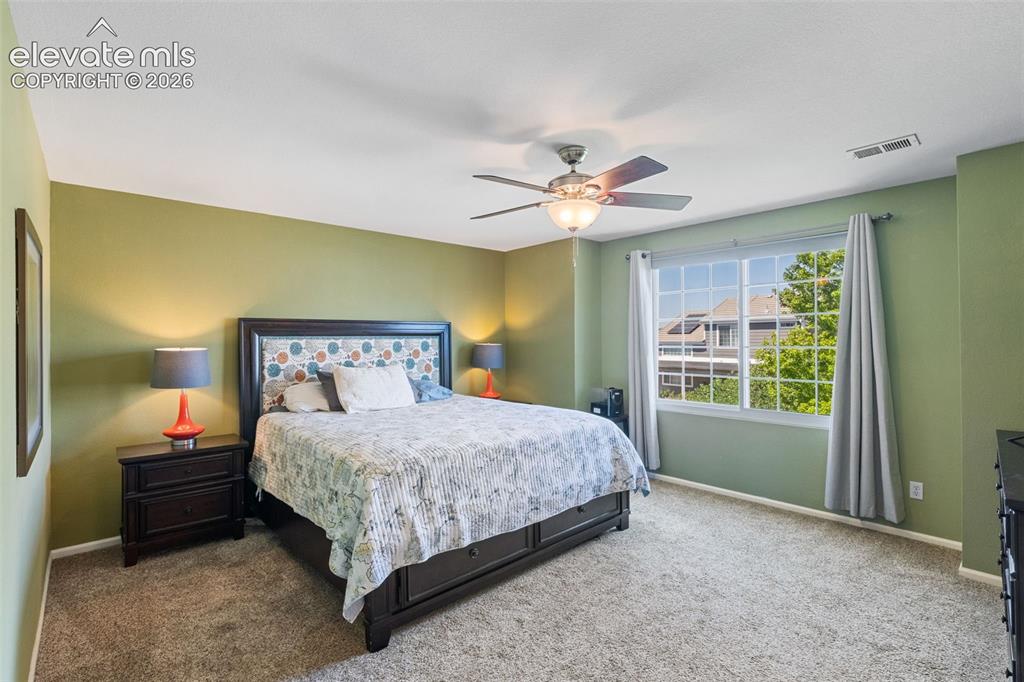 Image 21 of 39: Master bedroom. Note large window providing lots of light.