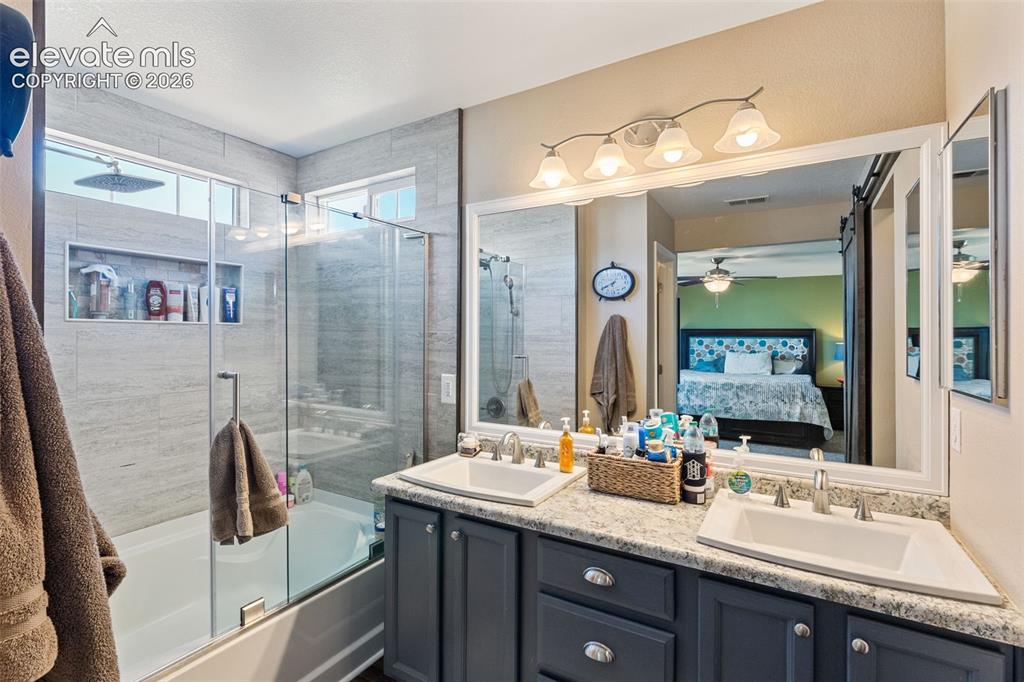Image 25 of 39: Master bath with double vanities,, shower and soaking tub.