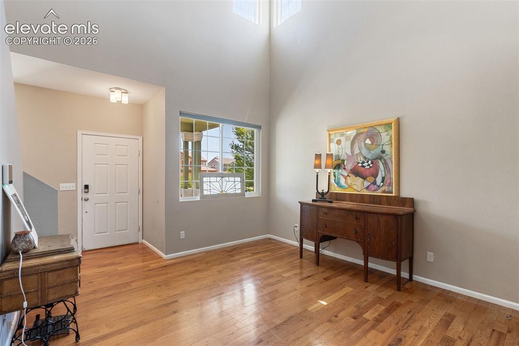 Image 7 of 39: Living room with large windows and view of patio.