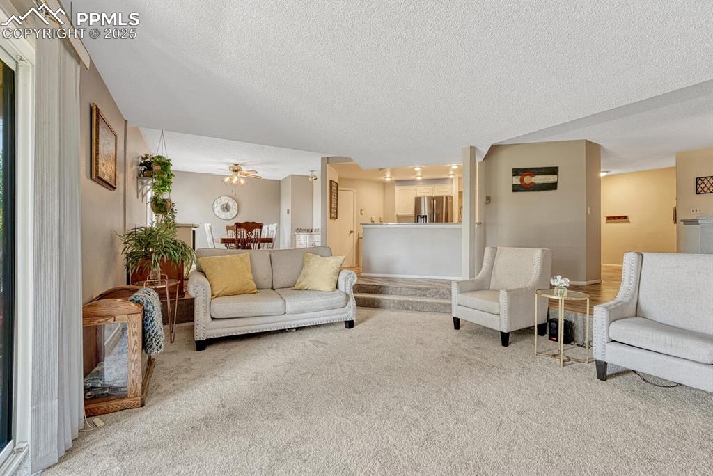 Image 17 of 48: Sunken living room looking into kitchen and dining room
