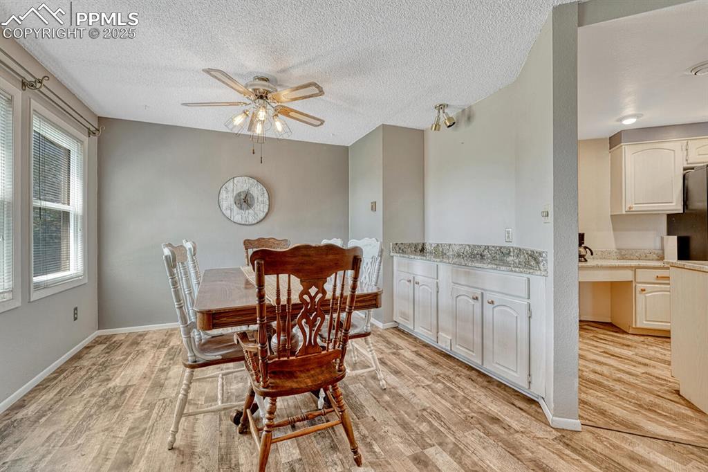 Image 20 of 48: Dining room with built in buffet with granite countertop and views of the l