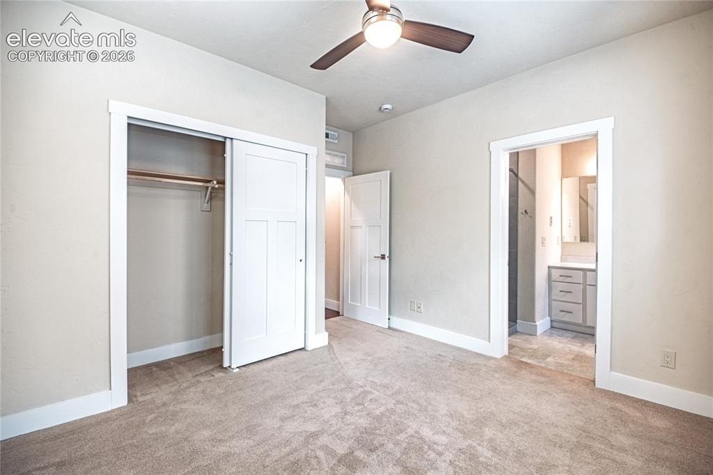 Image 17 of 50: Carpeted room with a ceiling fan