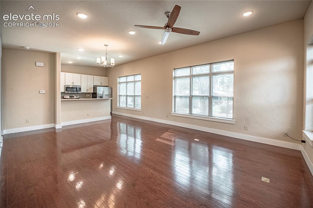 Image 27 of 50: Open concept living area featuring wood-finish flooring, recessed lighting,