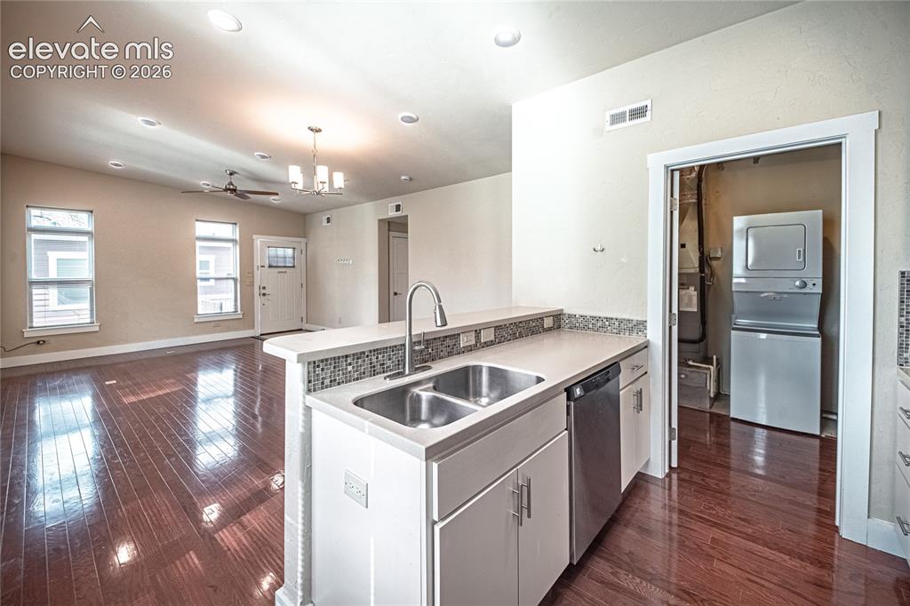 Image 33 of 50: Kitchen island with a double basin stainless steel sink, pull-down faucet,