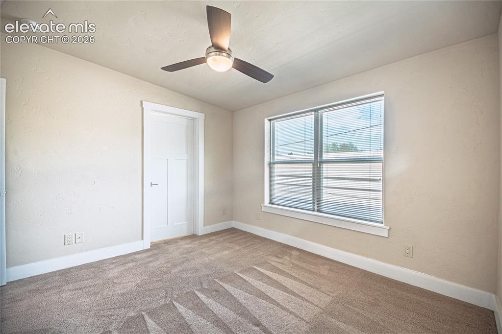 Image 34 of 50: Carpeted interior space featuring a ceiling fan with integrated lighting, a