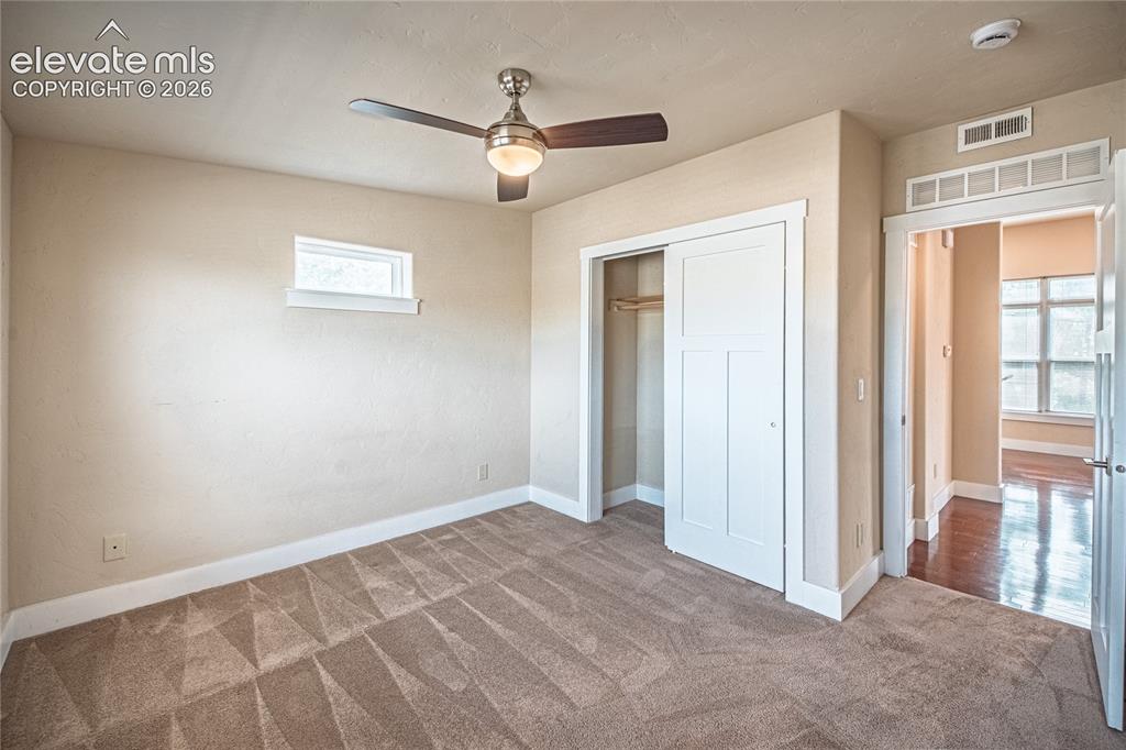 Image 36 of 50: Carpeted room featuring a ceiling fan with integrated lighting, a horizonta