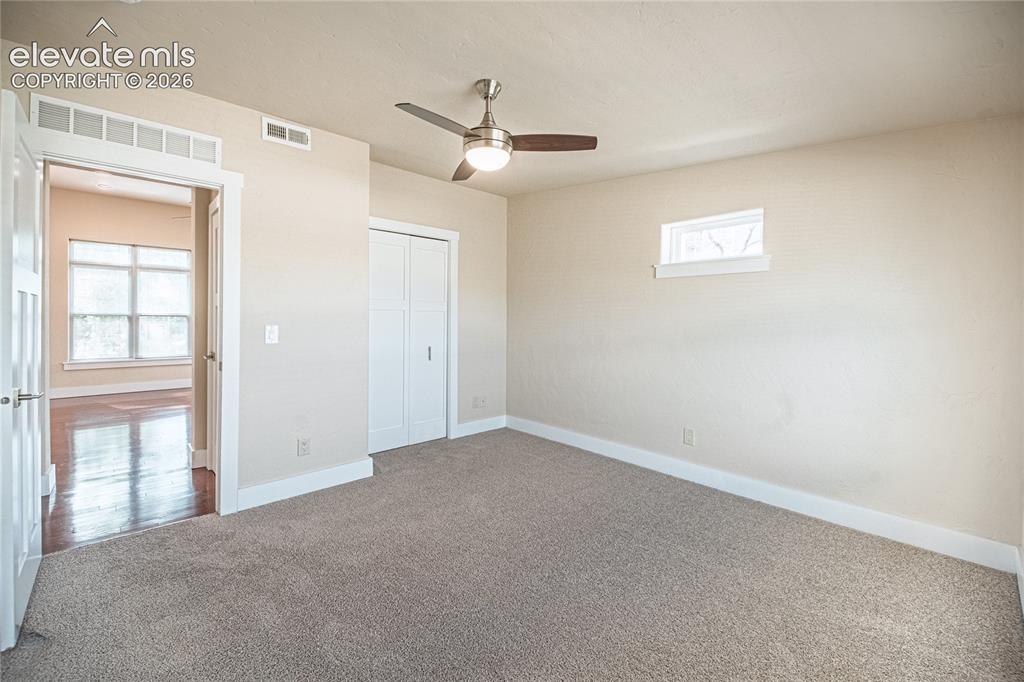 Image 39 of 50: Carpeted room featuring a ceiling fan with integrated lighting, a horizonta