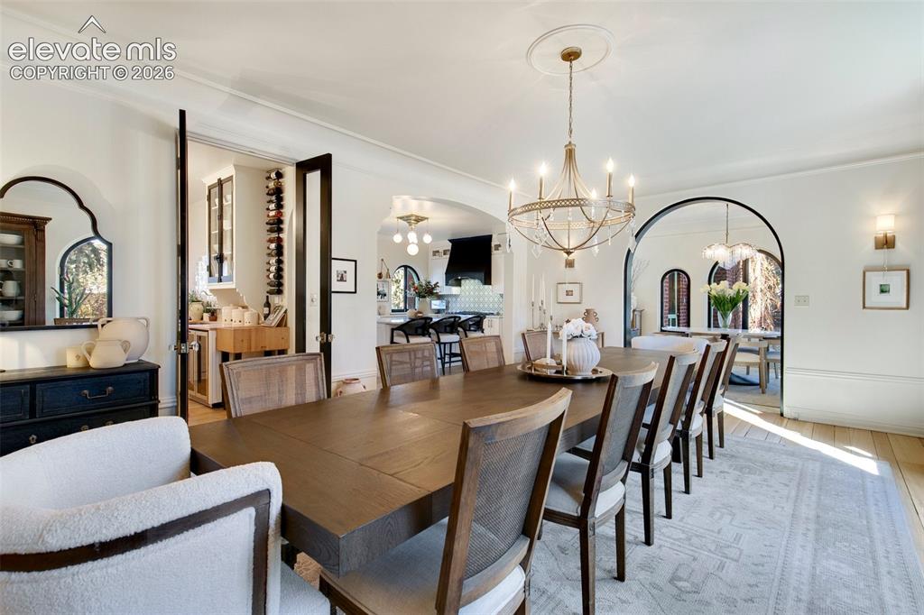 Image 12 of 50: Dining Room with sun room through Arch