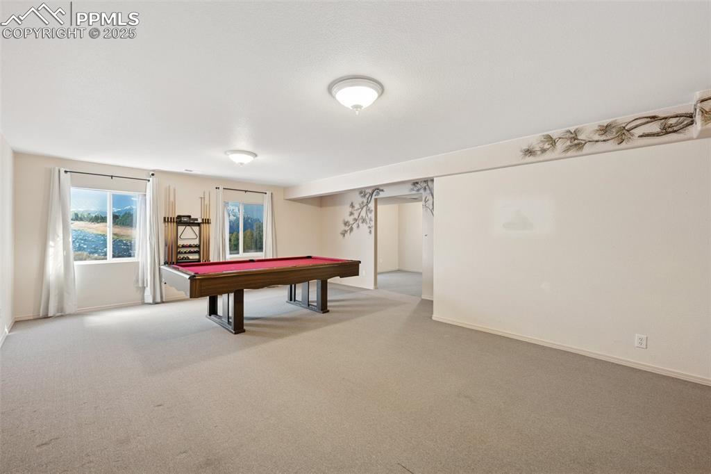 Image 17 of 27: Playroom with billiards table and carpet