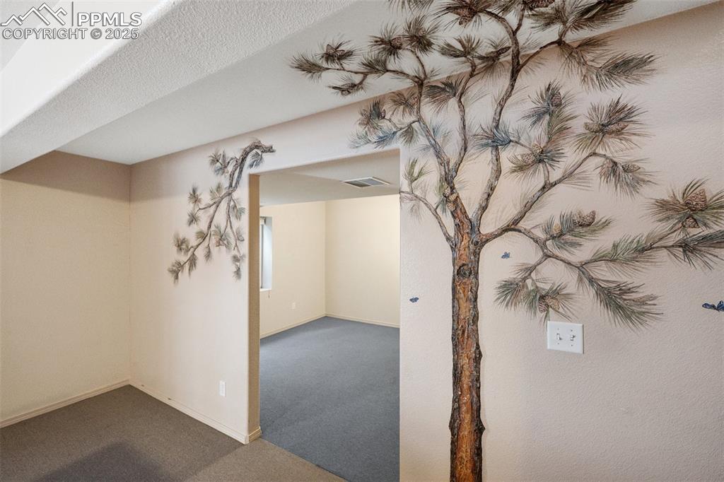 Image 18 of 27: Mural by Amy Spring, Colorado Artist Below grade area featuring carpet floo