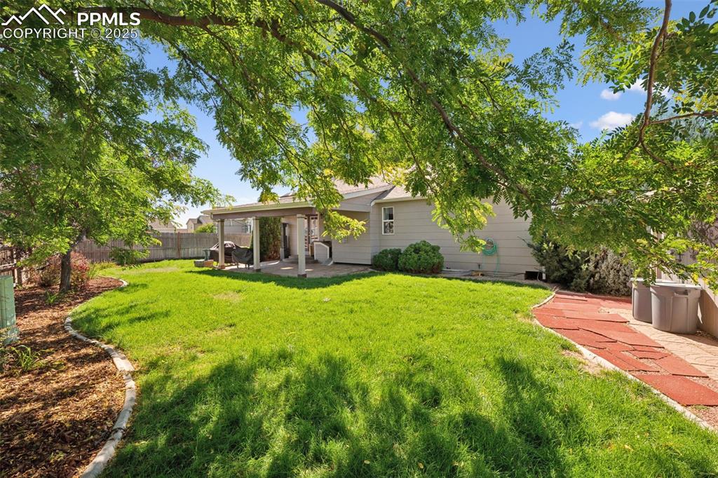 Image 2 of 27: Rear view of property with a patio and a fenced backyard