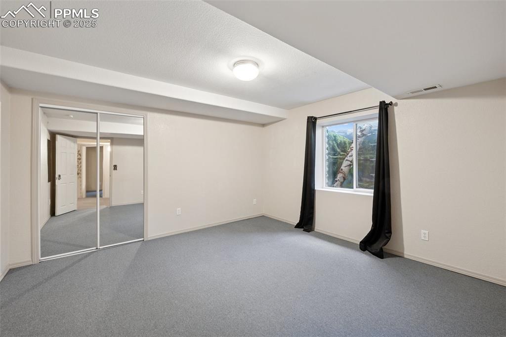 Image 21 of 27: Unfurnished bedroom featuring light colored carpet and a closet