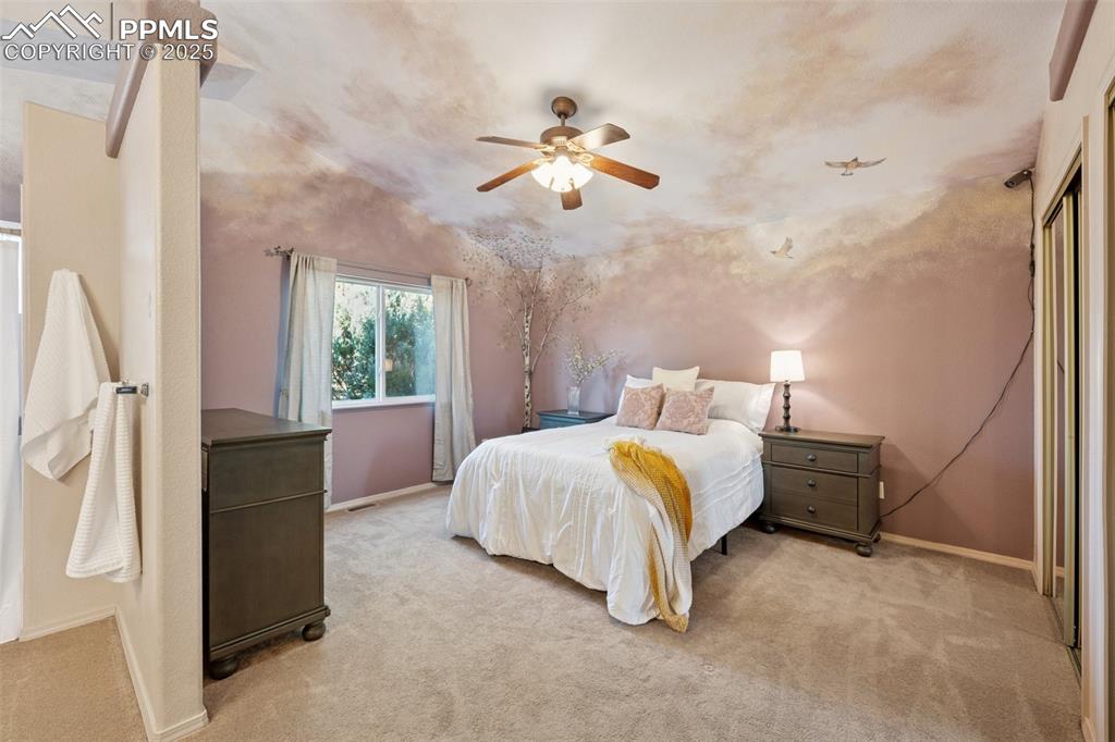 Image 9 of 27: Bedroom with light colored carpet and ceiling fan Mural by Amy Spring