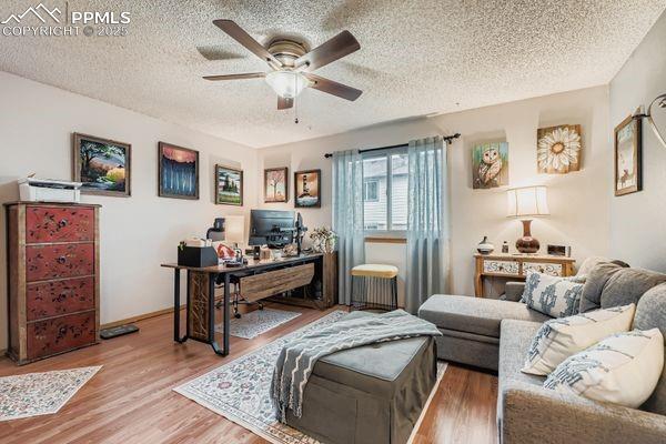 Image 7 of 15: Home office featuring wood finished floors, a textured ceiling, and ceiling