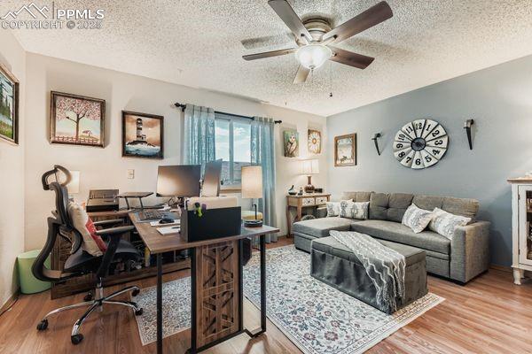 Image 8 of 15: Office space featuring a textured ceiling, light wood-style flooring, and c