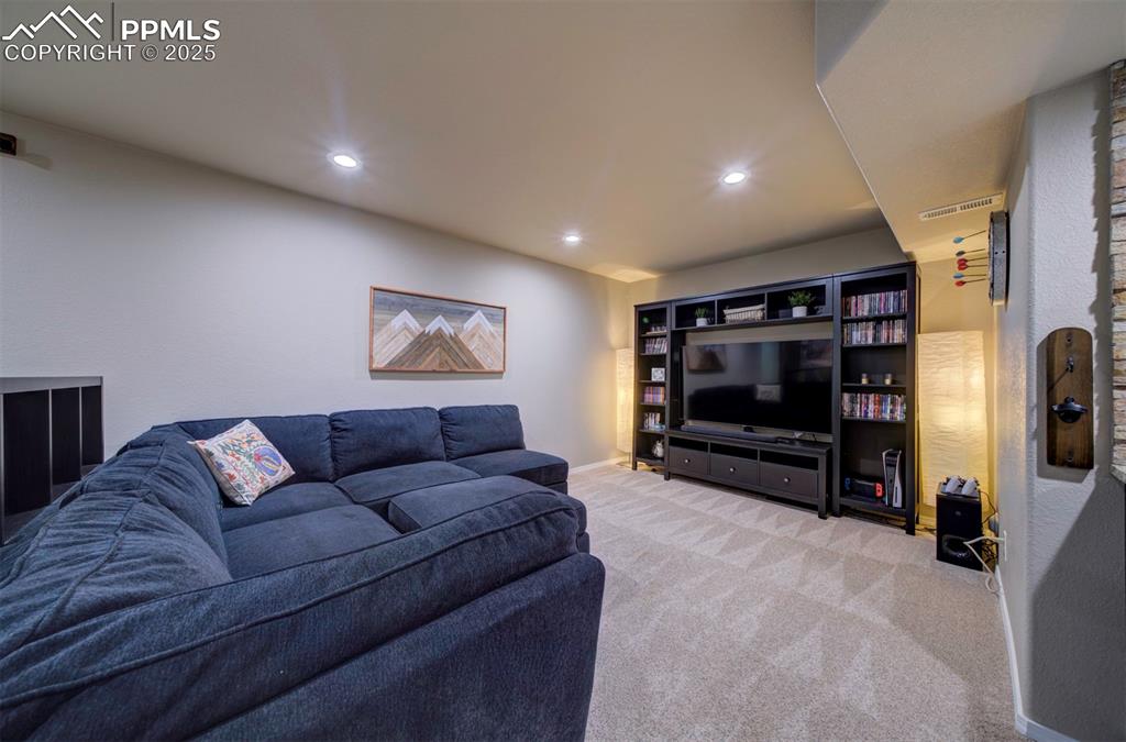 Image 31 of 46: Carpeted living area featuring recessed lighting
