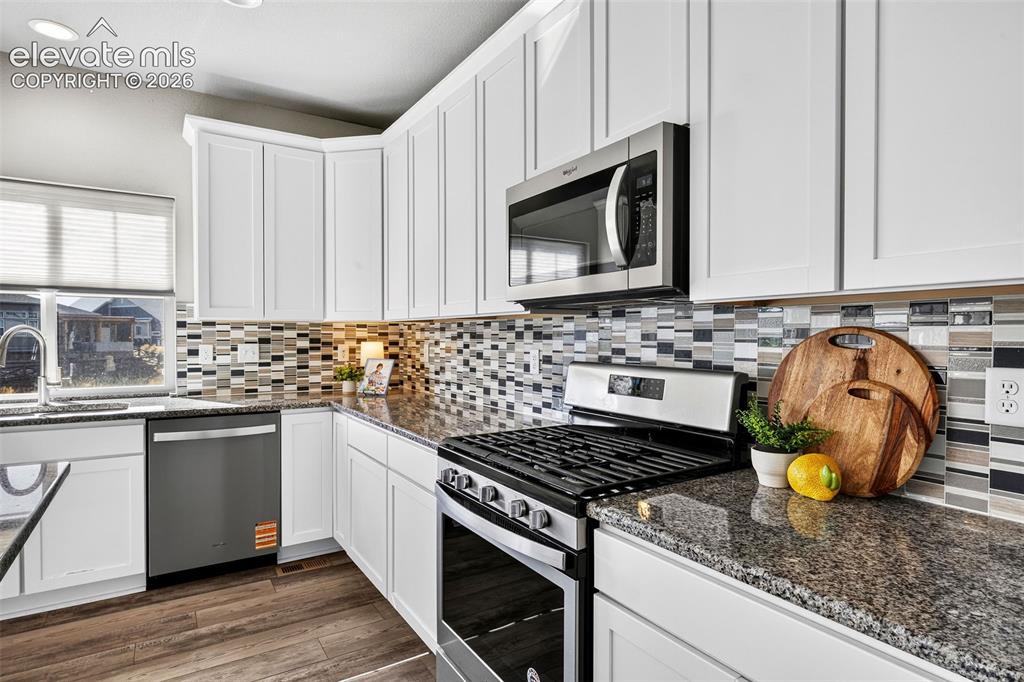 Image 12 of 48: The stainless steel appliances in this home are so new, they still have the