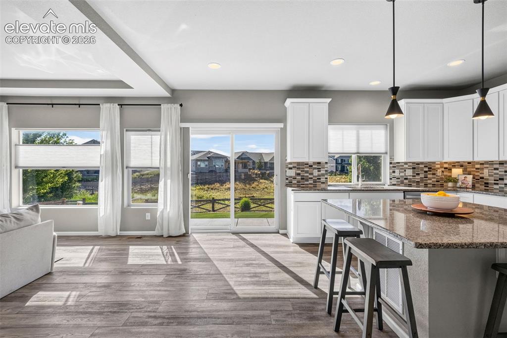 Image 14 of 48: Upgraded pendant lighting makes a statement over the island and adds extra 