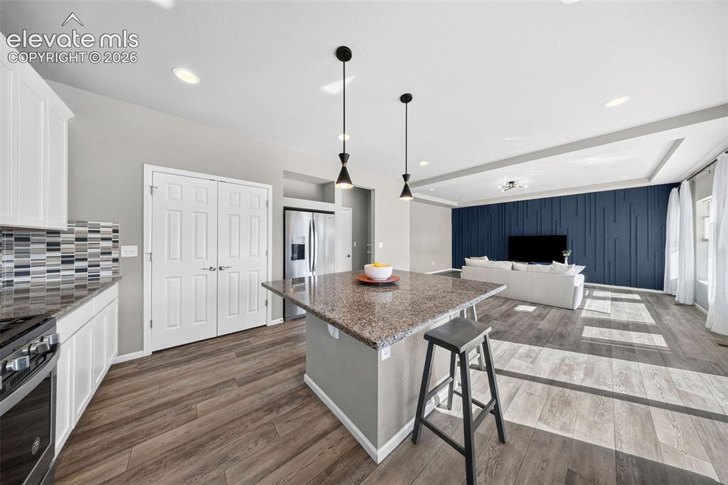 Image 15 of 48: Did you say corner walk-in pantry? Yes please! With wooden shelves too! Mos
