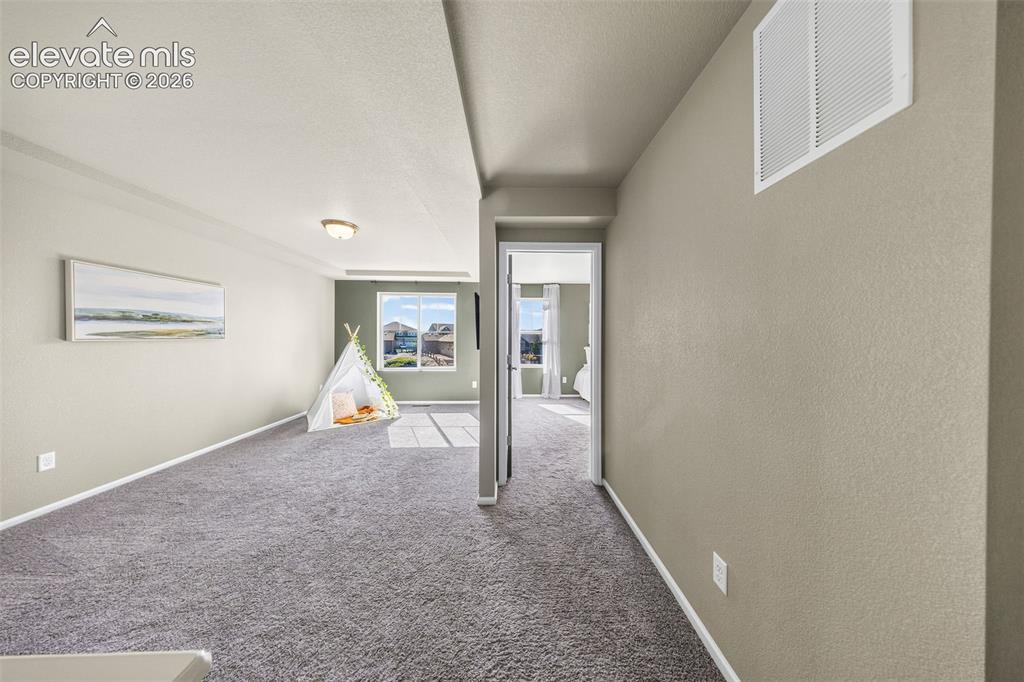 Image 18 of 48: The upper floor is spacious and bright with plenty of transition spaces bet