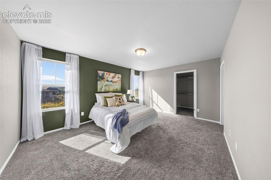 Image 19 of 48: The primary bedroom is a spacious retreat at the end of a long day. There i