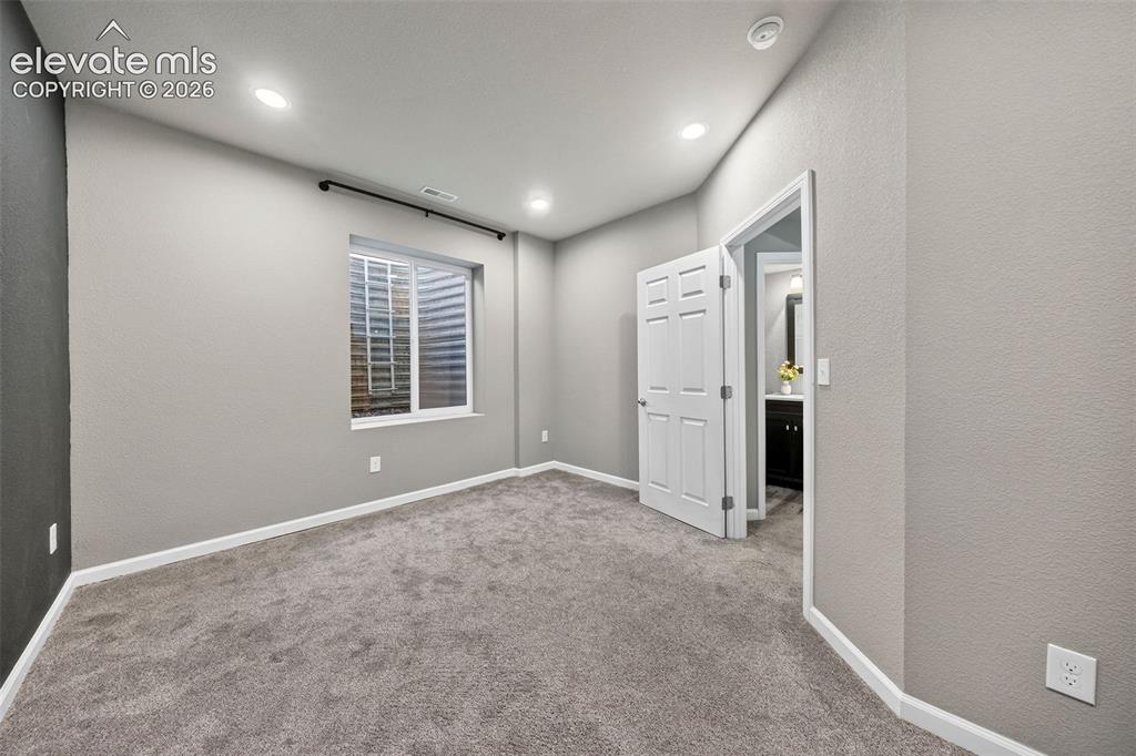 Image 33 of 48: View of the basement level bedroom - it is spacious, gets natural light, an